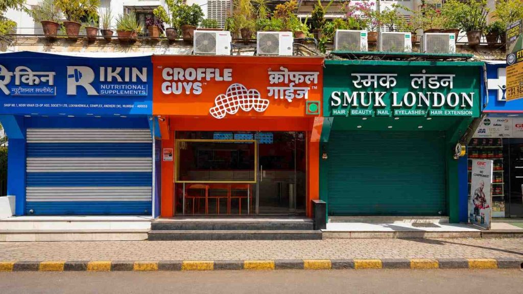The Croffle Guys interior, founders'-faces wall treatment