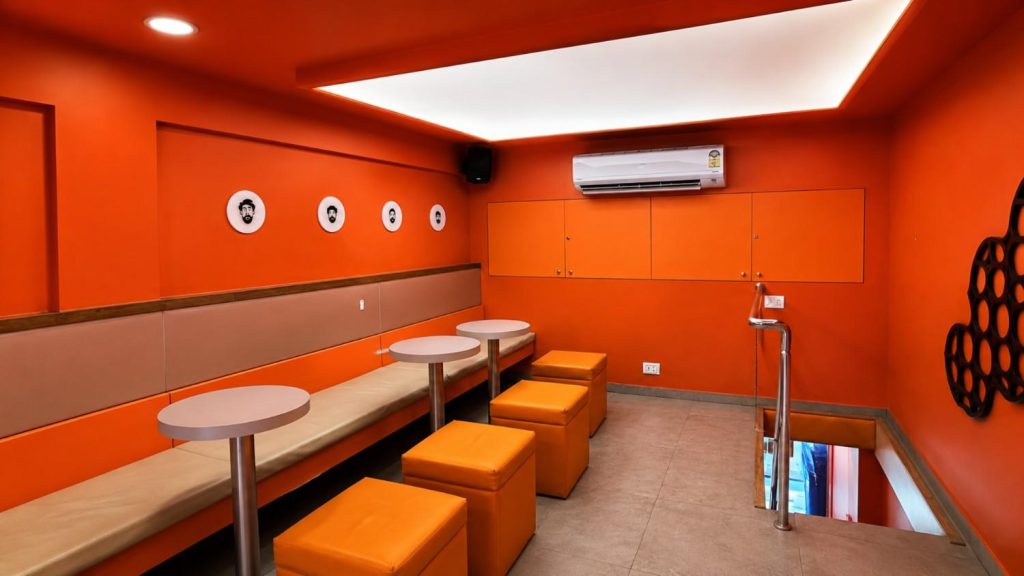 The Croffle Guys, wide interior view showing hero orange palette